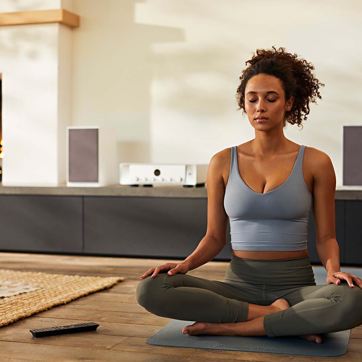 Marantz Model 40n Integrated Amplifier, Silver and Gold, on shelf behind woman doing yoga