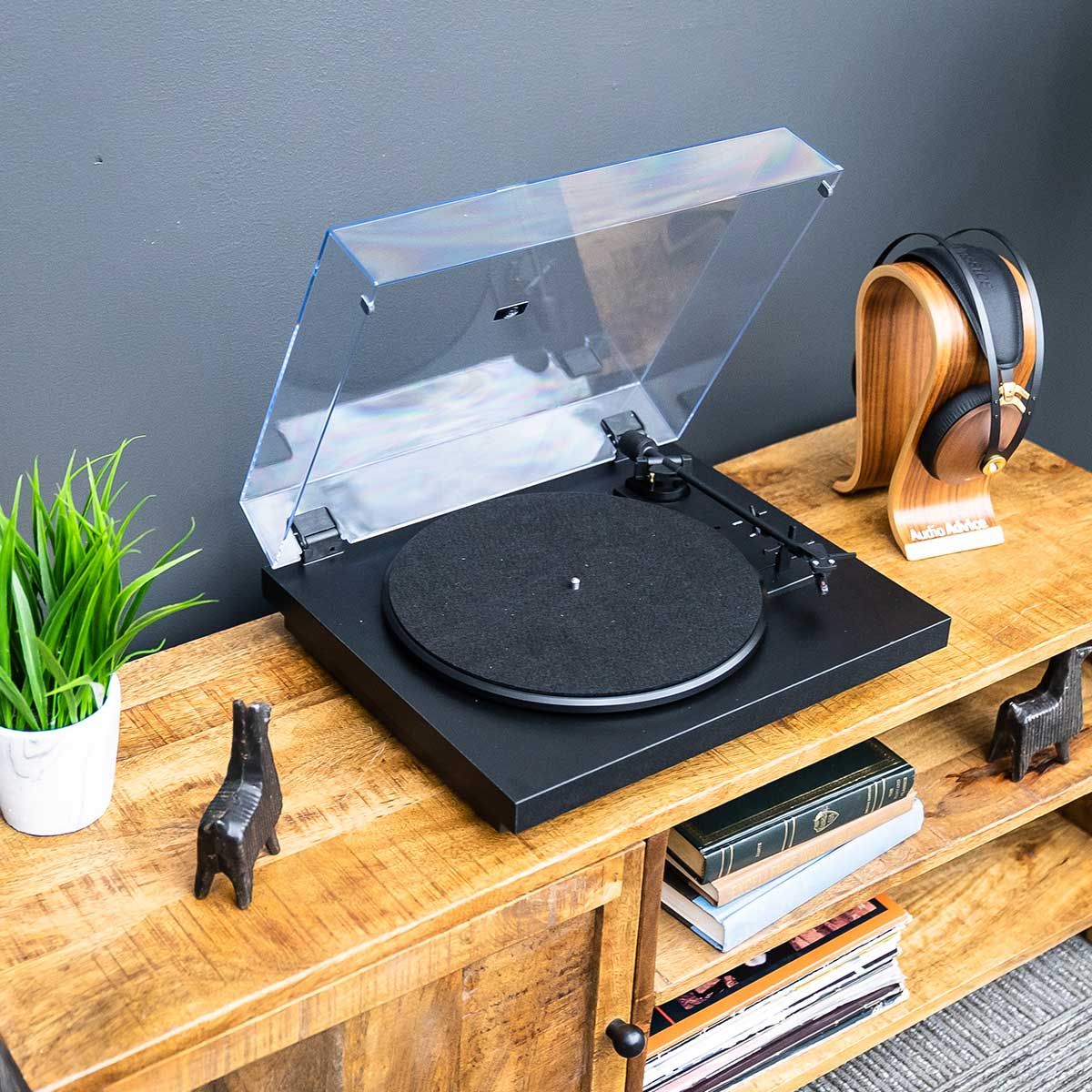 Pro-Ject Automat A1 Turntable sitting on cabinet with dustcover open