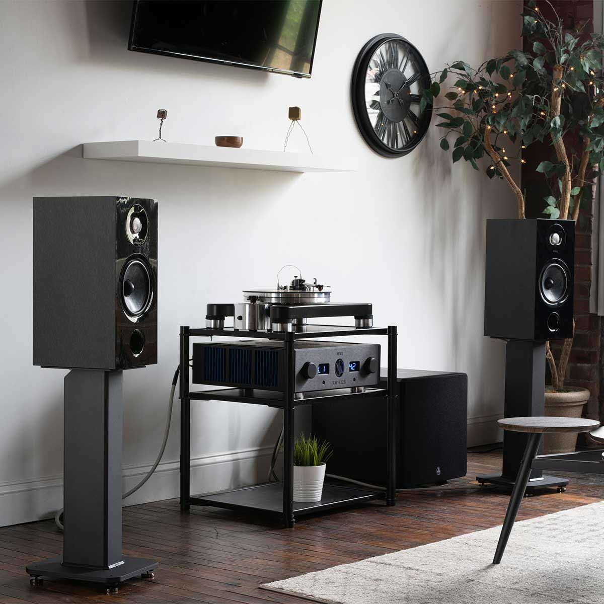 Kanto SX Speaker Stands, Black, set up with large bookshelf speakers in a home audio room