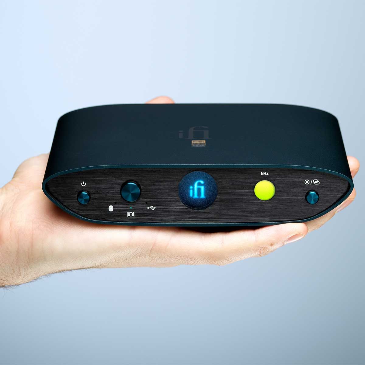 Close-up view of ifi Audio Zen One Signature front panel held in a human hand.