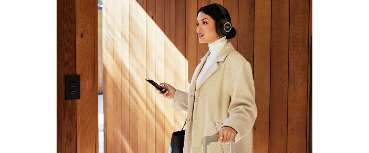 A female model wearing a pair of Mark Levinson № 5909 headphones at the airport.