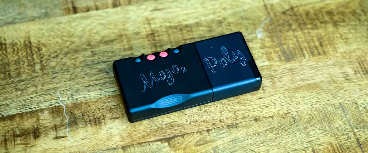 Close up shot of Chord Mojo 2 connected to Mojo Poly on a table.