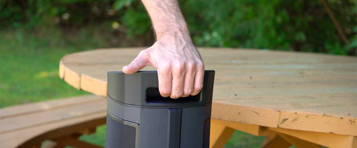 Close-up shot of the Soundcast VG5 Portable Waterproof Bluetooth Speaker's built-in rugged handle being gripped by a hand model.