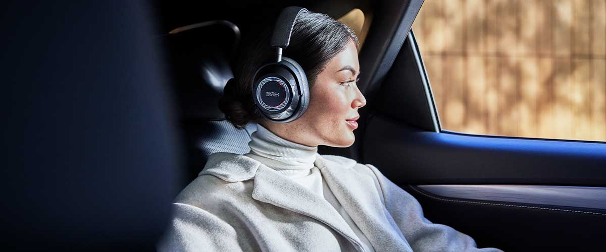 A female model wearing a pair of Mark Levinson № 5909 headphones in the car.