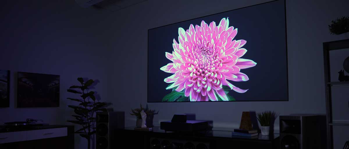 EPSON LS500 4K UST Projector projecting a 4K picture in a dark room.