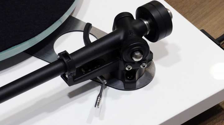 Make sure the tonearm is in the locked position and push the included counterweight onto the back of the tonearm.