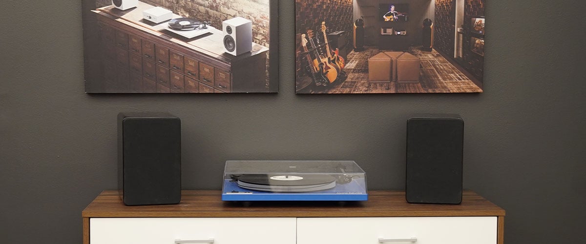 Peachtree M25 in black color on a table next to turntable.