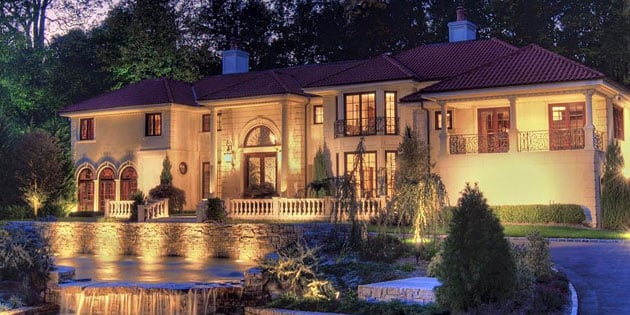 Photo of the outside of a large home lit up with lutron automated smart home lighting
