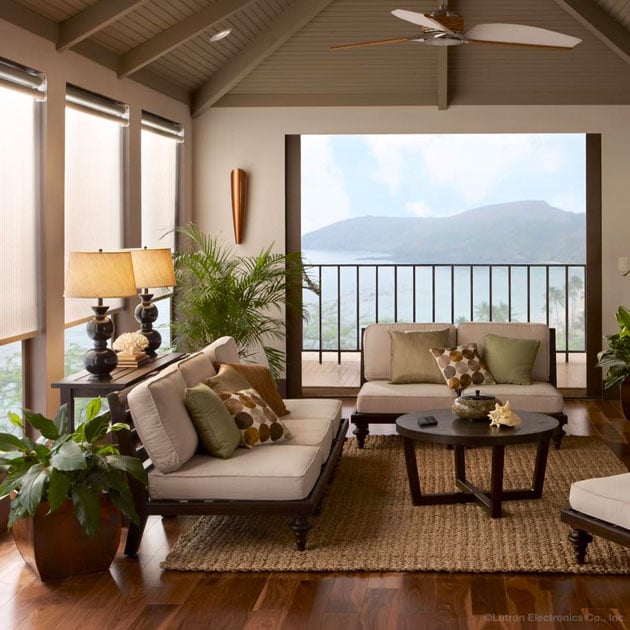 Lifestyle photo of Lutron smart automated shading in a living room overlooking a lake and mountains.