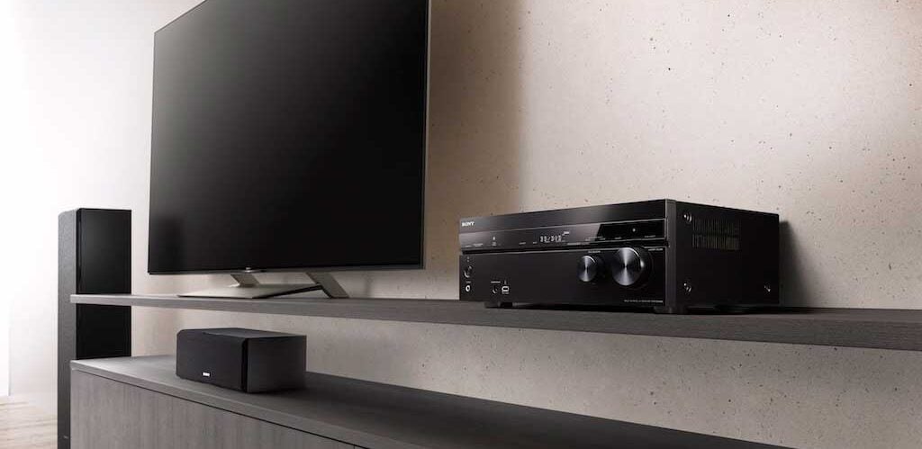 STR-DN1080 next to tv and speaker.