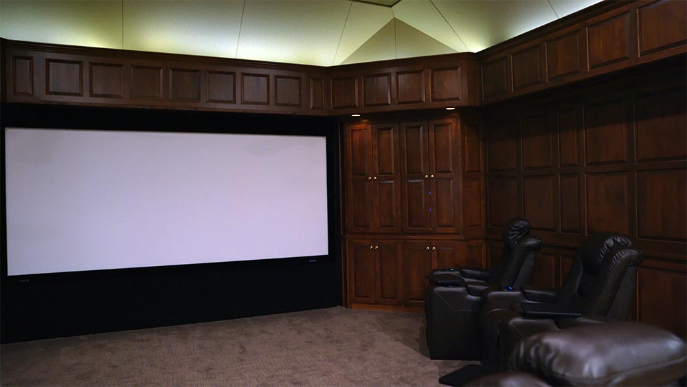 Photo of a home theater room showing projector screen before high-performance lighting is added