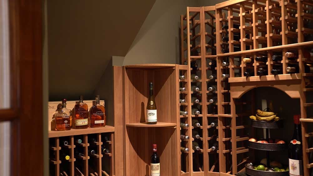 Wine cellar with wine bottles illuminated after lighting upgrades