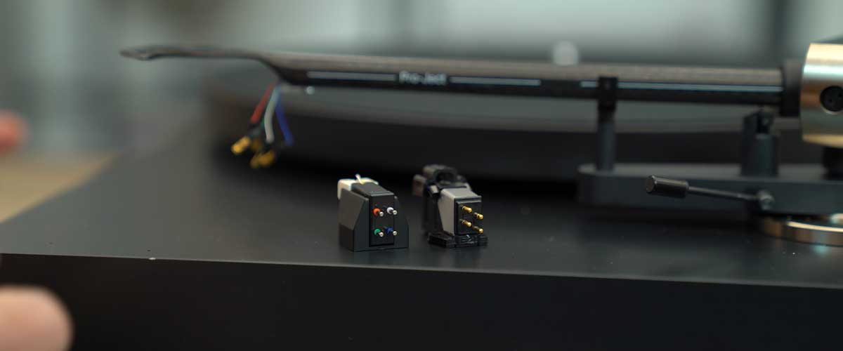a hand model showing how the Klipsch The Fives can be controlled with the remote control as a soundbar replacement using the HDMI ARC connection..