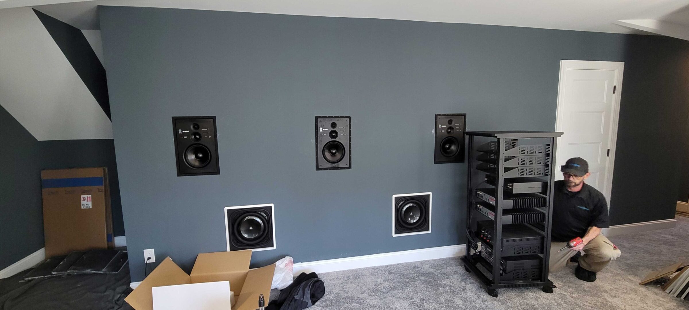Revel In-Wall Speakers & JL In-Wall Subs installed in home theater before the screen goes up