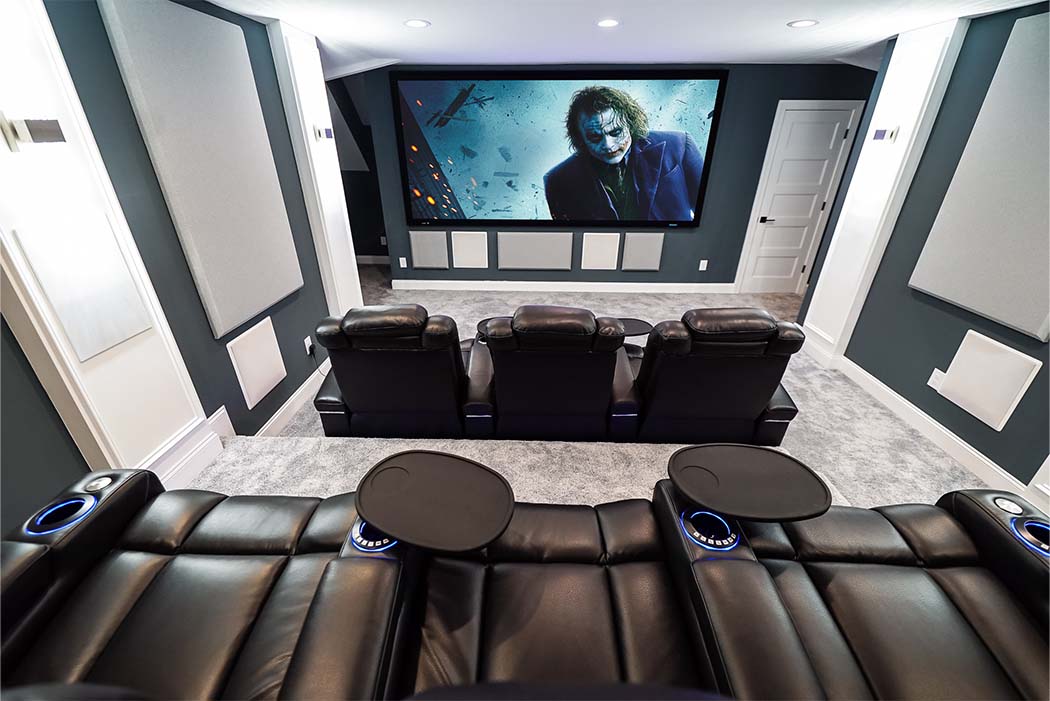7.4.4 home theater with two rows of Audio Advice revolutions with Joker playing on the screen