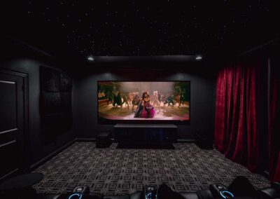 Home theater with The Greatest Showman playing on Stewart Filmscreen