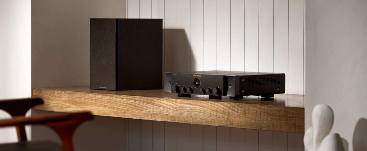 Marantz Stereo70s in black on a shelf next to a speaker